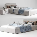Light Gray Upholstered Single Bed With Gray Brown Pillows Blue Blanket And White Nightstand
