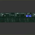 Row of Green Industrial Control Consoles With Multiple Displays And Panels