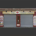 Small Commercial Building with White Roof Red Border Roller Shutters and Tobacco Post Office Signboards