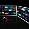 Multiple TVs On Display Wall With People Watching Colorful Dynamic Visuals