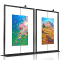 Two Black Frame Display Stands With Colorful Abstract And Landscape Paintings