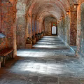 Elevator Hallway With Arched Red Brick Walls Stone Floor Benches And Natural Light