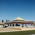 Waterfront Landscape With White Tents Yellow Spires And Sandy Beach Under Blue Sky