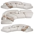 Modern Beige Sectional Sofa With Curved Design Soft Pillows And Throw Blanket