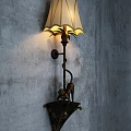 Vintage Wall Lamp With Monkey Sculpture Base And Linen Shade Illuminating Gray Textured Wall