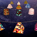 Colorful Geometric Lantern Art Installation Suspended On Strings Against Starry Sky Background