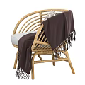 Natural Style Wicker Single Sofa With White Cushion Dark Blanket And Decorative Pillow