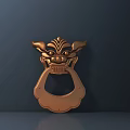 Copper Colored Door Handle with Animal Head Shape Horns and Facial Details on Dark Background