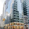 Bright Modern Commercial Storefront Window Display Along Downtown Urban Street Beneath Glass Curtain Wall Building