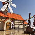 Cartoon Style Village Scene With Windmill Red Roofs And Plaza Decorations