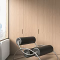 Stylish Lounge Chair Featuring Black Roller Design And Metal Frame Against Wooden Cabinet Window With Blinds