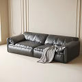 Stylish Black Leather Double Sofa With Striped Blanket And Light Colored Walls