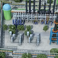 Industrial Plant With Green Water Tower Black Tall Towers Pipes Metal Structures And Surrounding Trees
