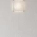 Modern Minimalist Wall Lamp on White Wall with Transparent Glass Lampshade and Metal Brackets