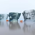 Large Head Sculpture Carvings Featuring Blue Gray Colors Person Standing Orange Chairs and Ground Reflection