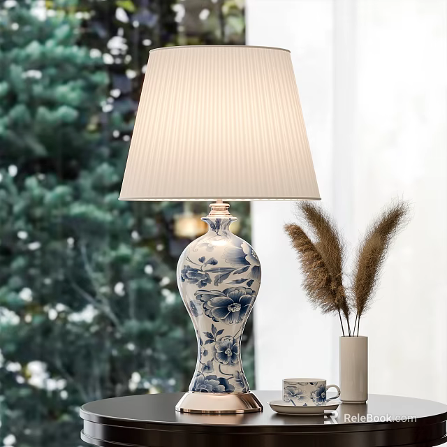 Blue And White Ceramic Table Lamp With Pleated Cream Lampshade Green Tree Background Pampas Grass 3d model 