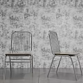 Stylish Leisure Chairs With Metal Frames And Wooden Seats Against Patterned Wallpaper