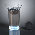 Transparent Glass Cup with Splashing Water Next to an Oreo Cookie