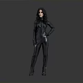 Woman In Black Tight Fitting Suit Standing With Hands On Hip Against Gray Gradient Background