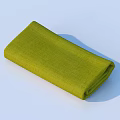 Neatly Folded Green Cloth on Light Blue Background with Soft Shadow