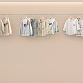 Cute Soft Kids Clothes Display With Light Colors And Cartoon Prints On Hangers