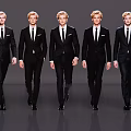 Group of Men in Black Formal Suits Walking on Fashion Runway