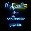 Blue Neon Lightbox With Yellow Frame Showing My Growth Continuous Process On Black Background