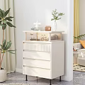 White Chest of Drawers with Books Potted Plant and Decor in Modern Indoor Space