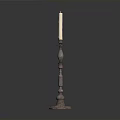 Metal Candle Holder With Decorative Column Base And Lit White Candle On Dark Background