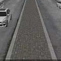 Classic Cobblestone Central Median Separating Two Durable Asphalt Road Lanes For Daily Passenger Vehicle Travel