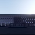 Modern Hotel Building With White And Brown Facade Large Glass Windows Trees And Parking Area