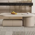 Modern Beige Coffee Table With Sleek Surface Bowl of Fruits Cup and Oval Top on Rug