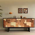 Modern Wooden Patchwork Console Cabinet With Orange Table Lamp Decorative Paintings And Green Plant