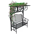 Outdoor Iron Bench with Decorative Overhead Frame Adorned with Vines and Pink Flowers