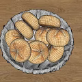 Freshly Baked Round Bread Rolls With Cross Patterns In White Basket On Wooden Table