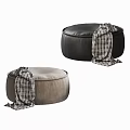 Two Stylish Black and Taupe Ottomans with Plaid Blankets Draped Over