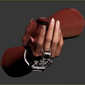 Red Hand Model Displaying Stylish Wrist Accessory With Geometric Patterns And Black Gemstones