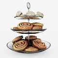 Freshly Baked Cinnamon Rolls on Three Tiered Glass Stand with Mini Pastry Buns