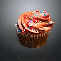 Delicious Cupcake With Brown Frosting And Colorful Sprinkles On Paper Cup