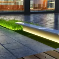 Modern Outdoor Garden Ornament Featuring Illuminated Bench Green Grass And Stone Pavement