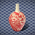 Ceramic Vessel With Red And White Plum Blossom Bird Design Against Blue Wave Pattern Background
