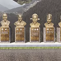 Detailed Bronze Figure Bust Sculptures With Inscribed Bases Against Mountain Forest Landscape