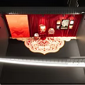 Traditional Decorative Display Area With Red Backdrop Fan And Wall Artworks