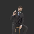 Man in Formal Suit Making OK Hand Gesture Sitting on Wooden Stool Against Black Background