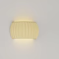 Cream Colored Ribbed Wall Lamp With Soft Glow Mounted On White Wall