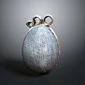 Metallic Textured Oval Household Item With Two Ring Decorations On Top