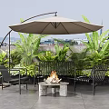 Stylish Outdoor Sofa Set With Fire Pit Umbrella And Green Plants On Patio