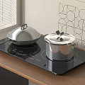 Sleek Black Induction Cooktop with Silver Pots on Wooden Kitchen Counter
