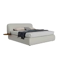 Modern Light Colored Double Bed With Upholstered Headboard Pillows And Attached Wooden Side Table
