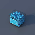 Decorative Ornament Set With Transparent Cube Box Containing Blue Spheres And Blue Label FASHION Text